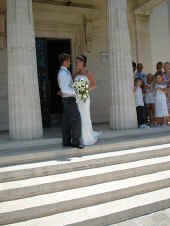 Standing on the steps of the registry office for a wedding in Paphos Cyprus 