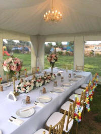 Tables, chairs, tableware and decorations inside a small marquee for hire in Cyprus