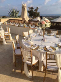 Table settings and chairs in an open area or balcony